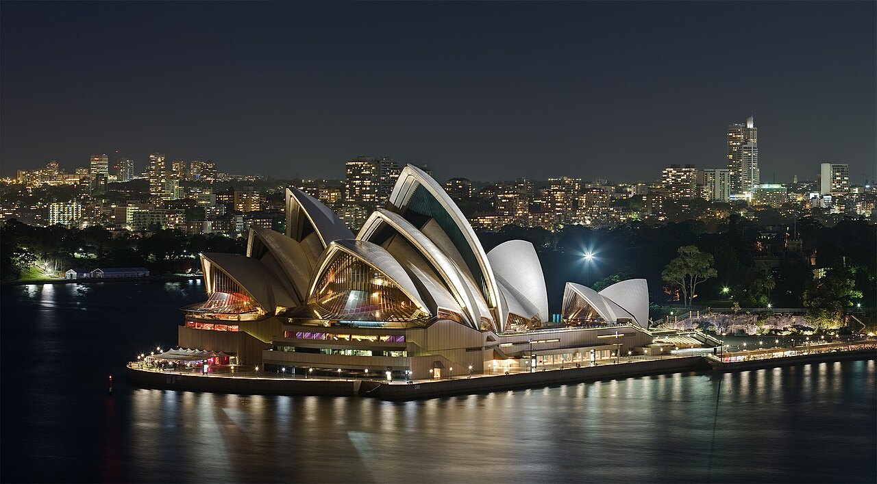 Sydney Opera House at night, its ceramic-tiled shells lit